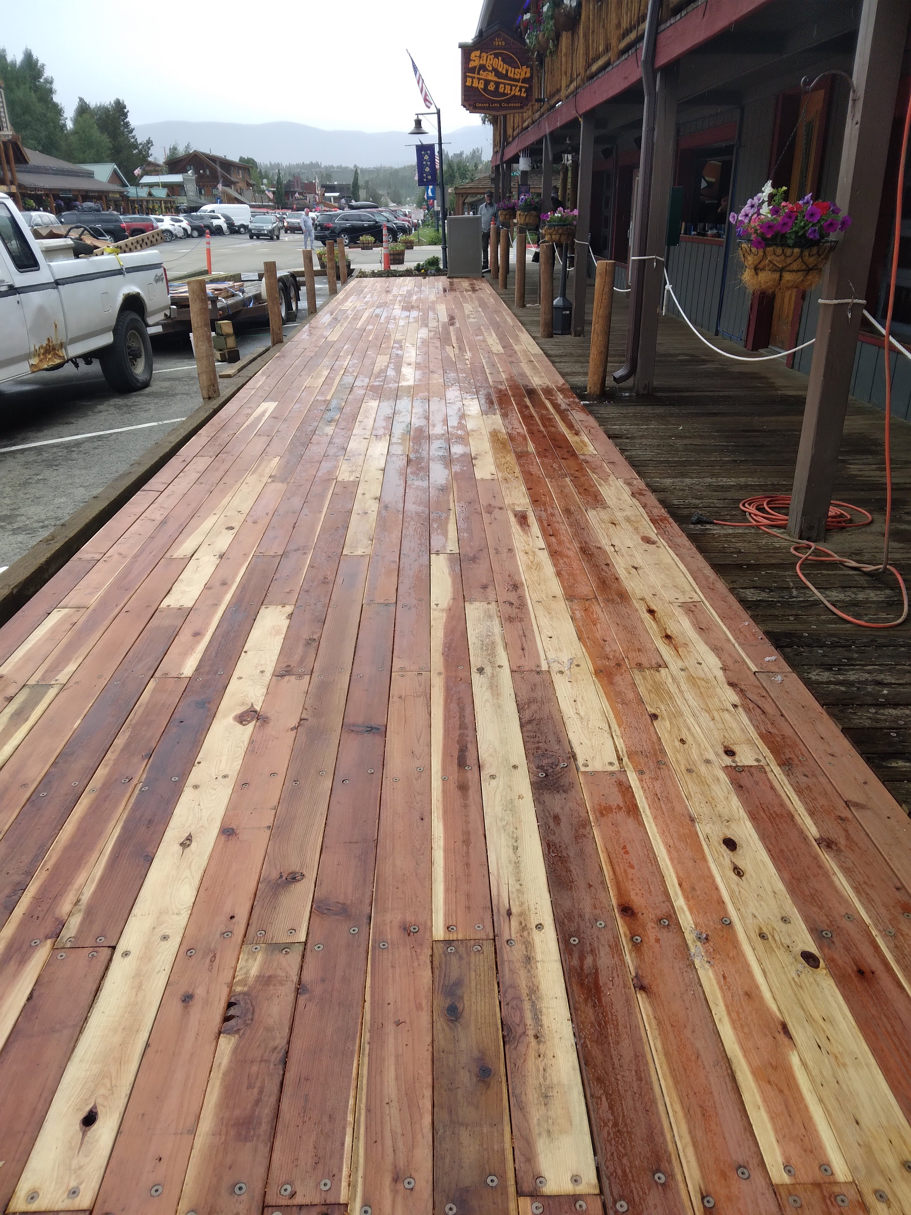 Finished boardwalk surface with posts and chain near Sagebrush BBQ and Grill